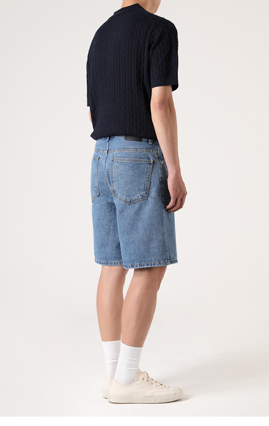 반팔니트와 함께 착용한 중청컬러의 버뮤다팬츠 기장의 미디엄블루 하프데님을 착용한 모델사진