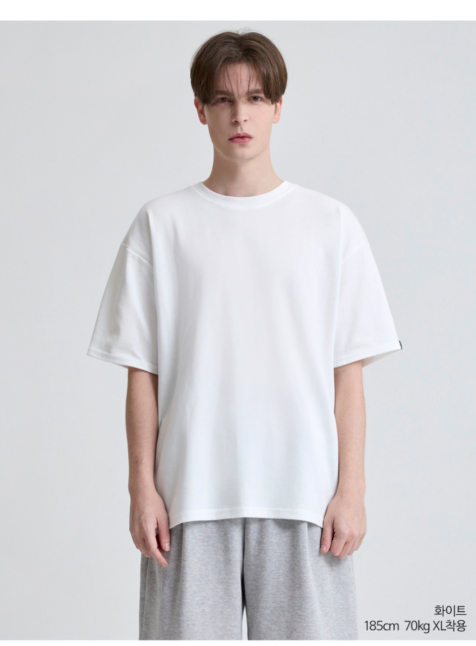 흰색 팔에 포인트로 라벨이 붙어있는 옷을 입은 남자사진