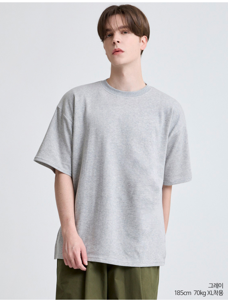 회색옷 팔에 포인트로 라벨이 붙어있는 옷을 입은 남자사진