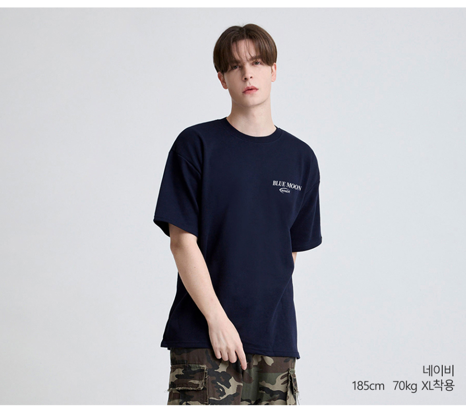 네이비색상 뒷면에 달 프린팅이 있는 반팔 티셔츠를 입은 남자사진
