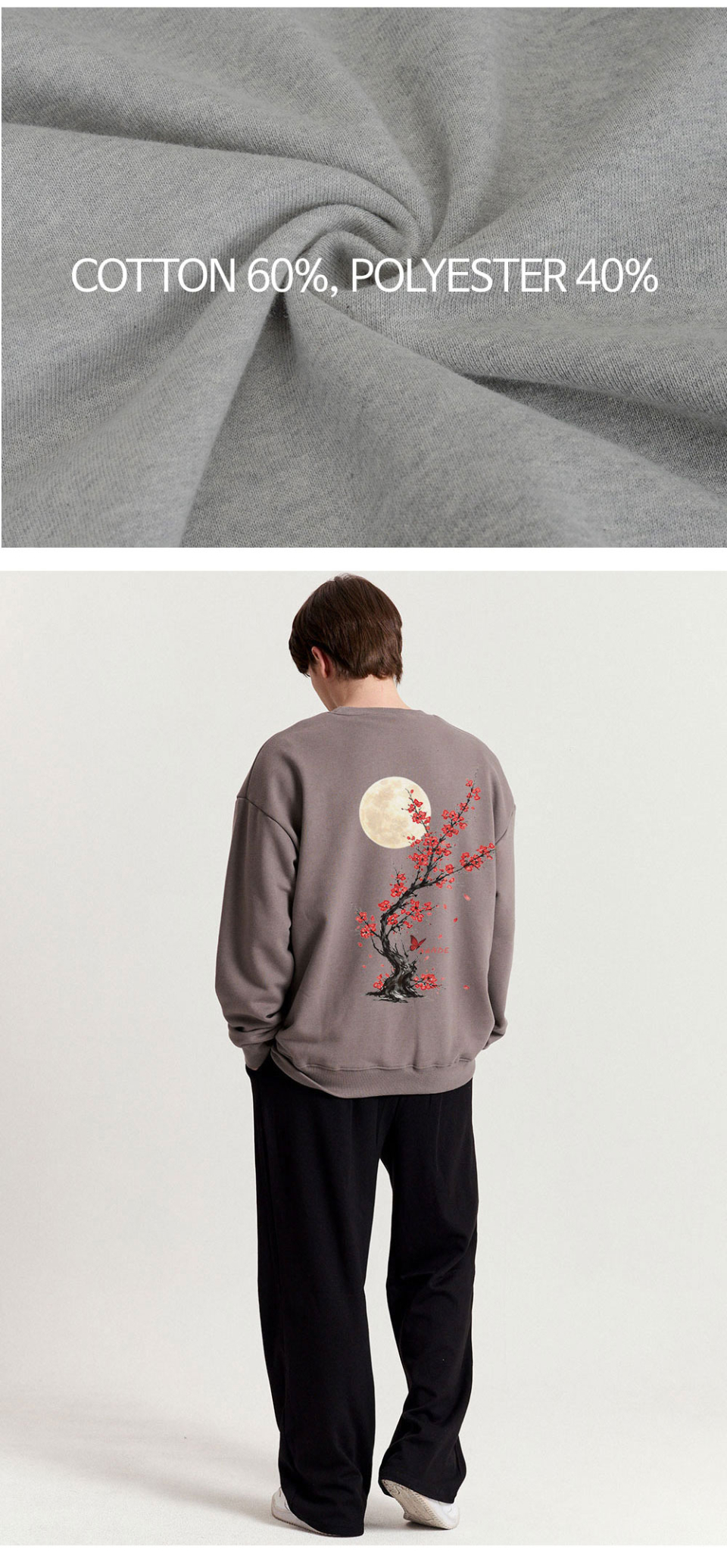 다크그레이색상 등에 꽃이 프린팅 되어있는 맨투맨을입은 남자 사진