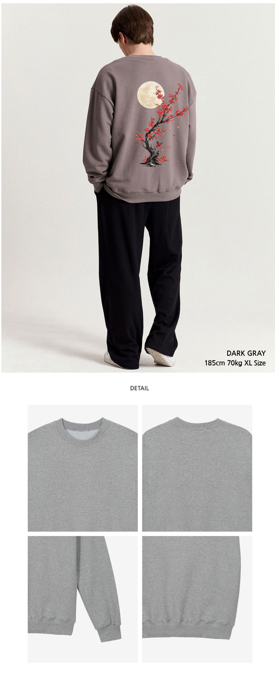 다크그레이색상 등에 꽃이 프린팅 되어있는 맨투맨을입은 남자 사진