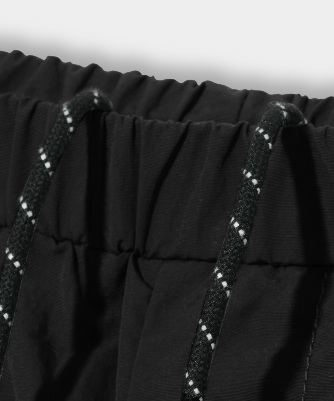 EUG NYLON PARACHUTE CURVED BANDING PANTS_BLACK