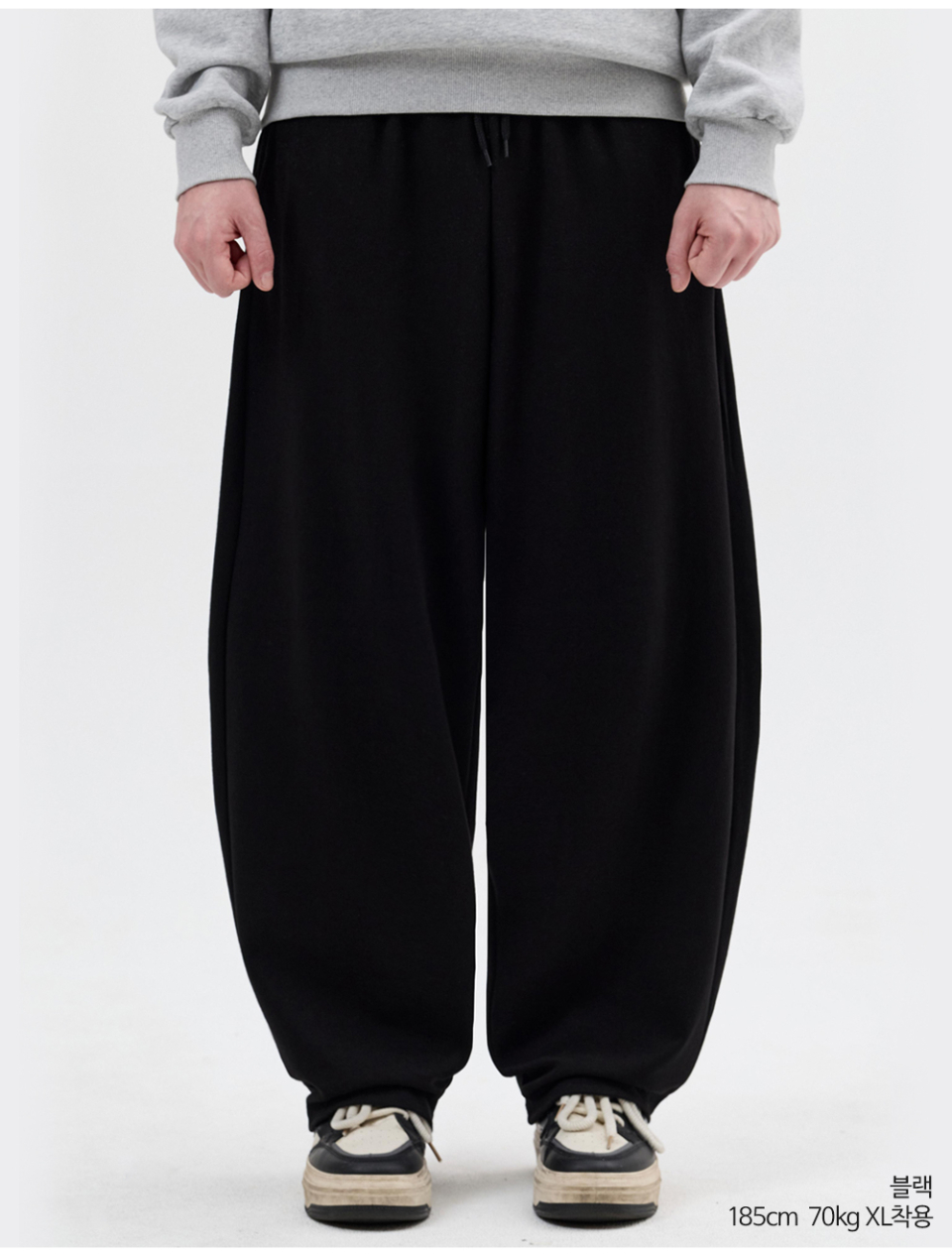 블랙색상 사이드턱이있는 벌룬 팬츠를 입은 남자사진