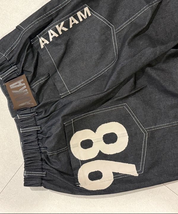 MUSINSA公式 | AAKAM 98 Printed Knee Pin-tuck Denim Pants (Black)