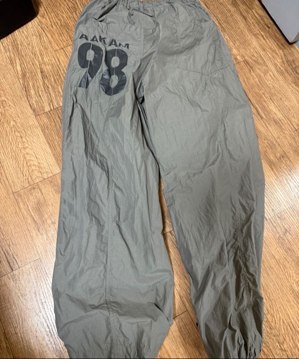 MUSINSA | AAKAM 98 Printed Knee Pin-tuck Nylon Pants (Khaki)