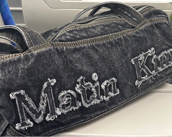 MUSINSA | MATIN KIM LOGO WASHED DENIM DUFFEL BAG IN BLACK