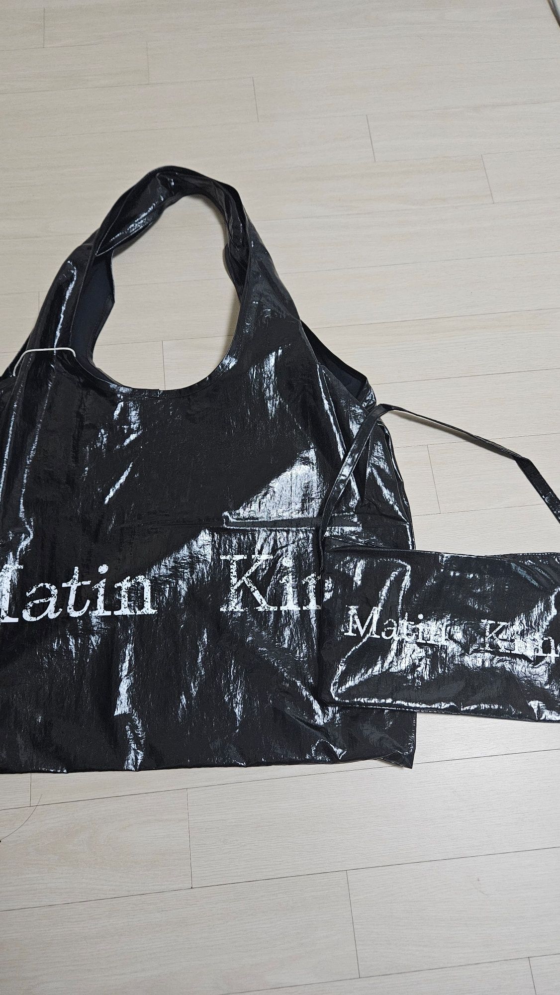 MUSINSA | MATIN KIM MATIN CRACKED LOGO GLOSSY ECOBAG IN
