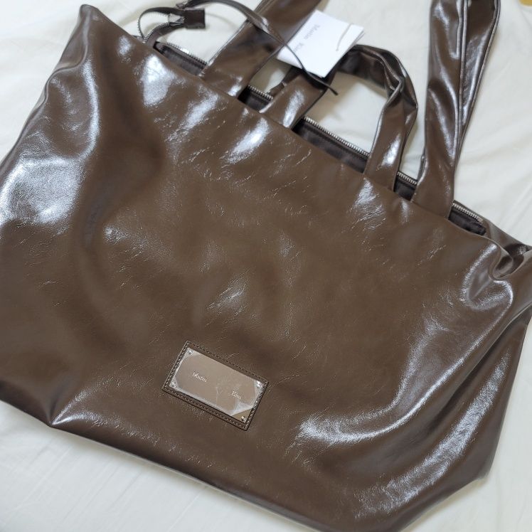 MUSINSA | MATIN KIM EMBOSSED LOGO LEATHER MAXI BAG IN BLACK