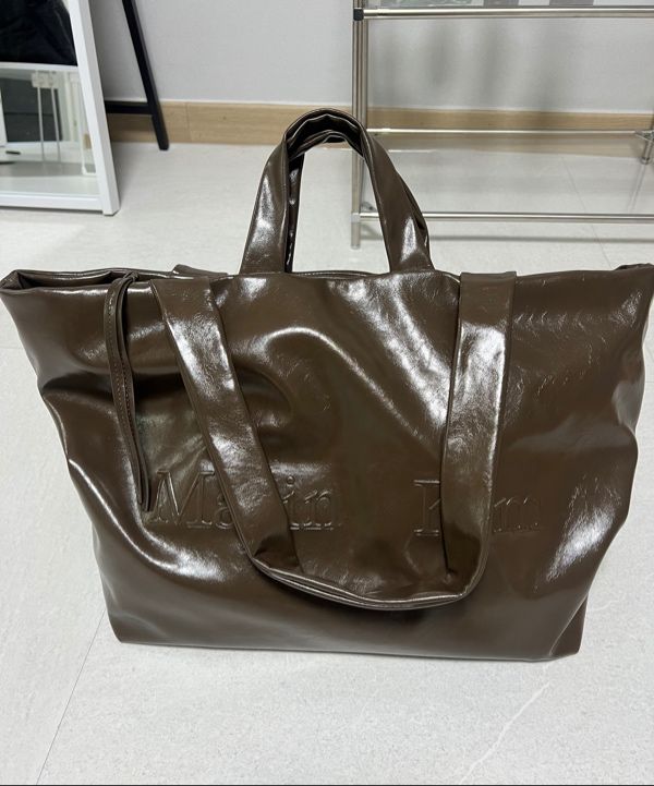 MUSINSA | MATIN KIM EMBOSSED LOGO LEATHER MAXI BAG IN BLACK