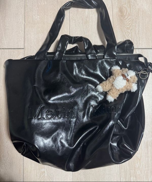 MUSINSA | MATIN KIM EMBOSSED LOGO LEATHER MAXI BAG IN BLACK