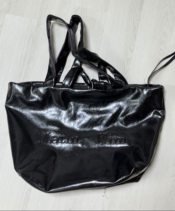 MUSINSA | MATIN KIM EMBOSSED LOGO LEATHER MAXI BAG IN BLACK