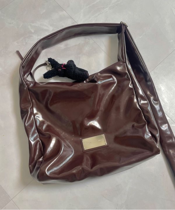 MUSINSA | MATIN KIM EMBOSSED LOGO LEATHER SHOULDER BAG IN