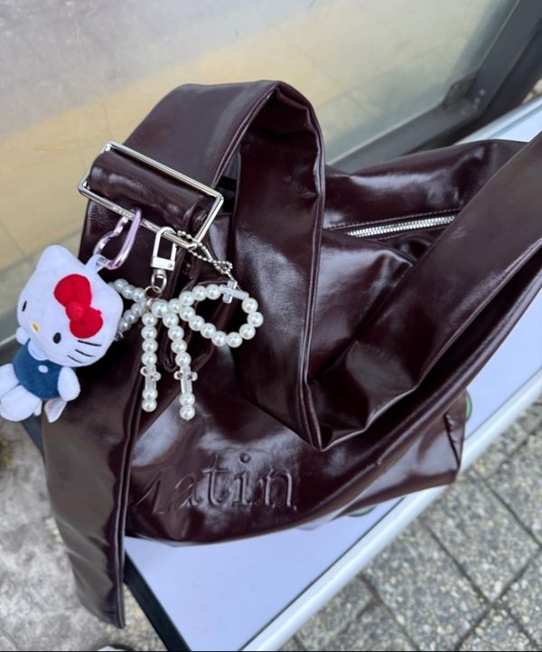 MUSINSA | MATIN KIM EMBOSSED LOGO LEATHER SHOULDER BAG IN