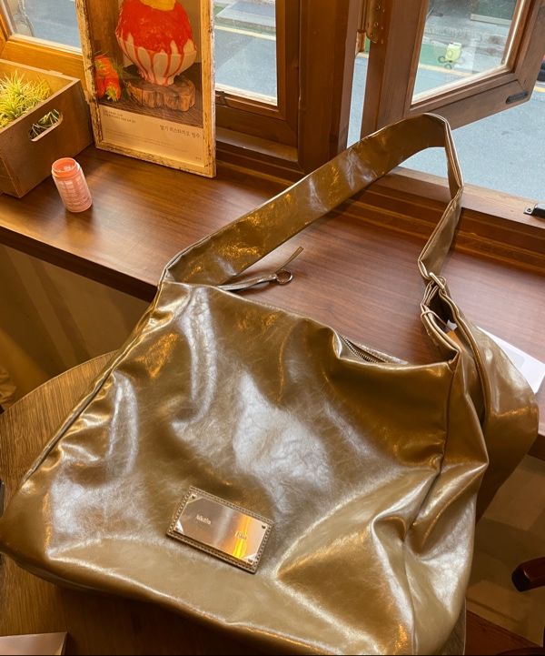 MUSINSA | MATIN KIM EMBOSSED LOGO LEATHER SHOULDER BAG IN KHAKI