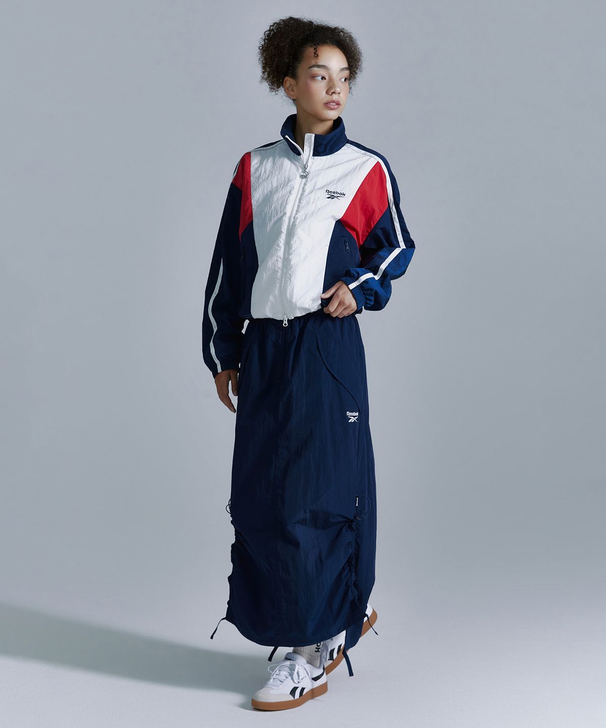리복(REEBOK) 우븐 스트링 스커트 (W) - 네이비