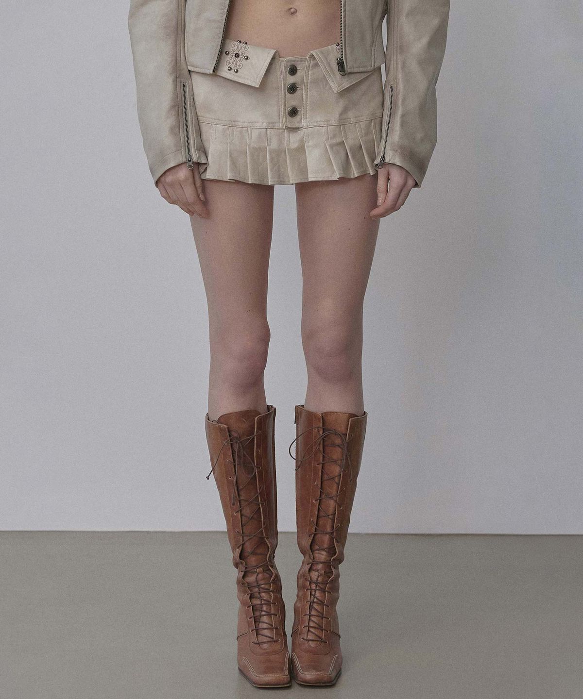 스컬프터(SCULPTOR) Western Faux Leather Micro Skirt Ivory