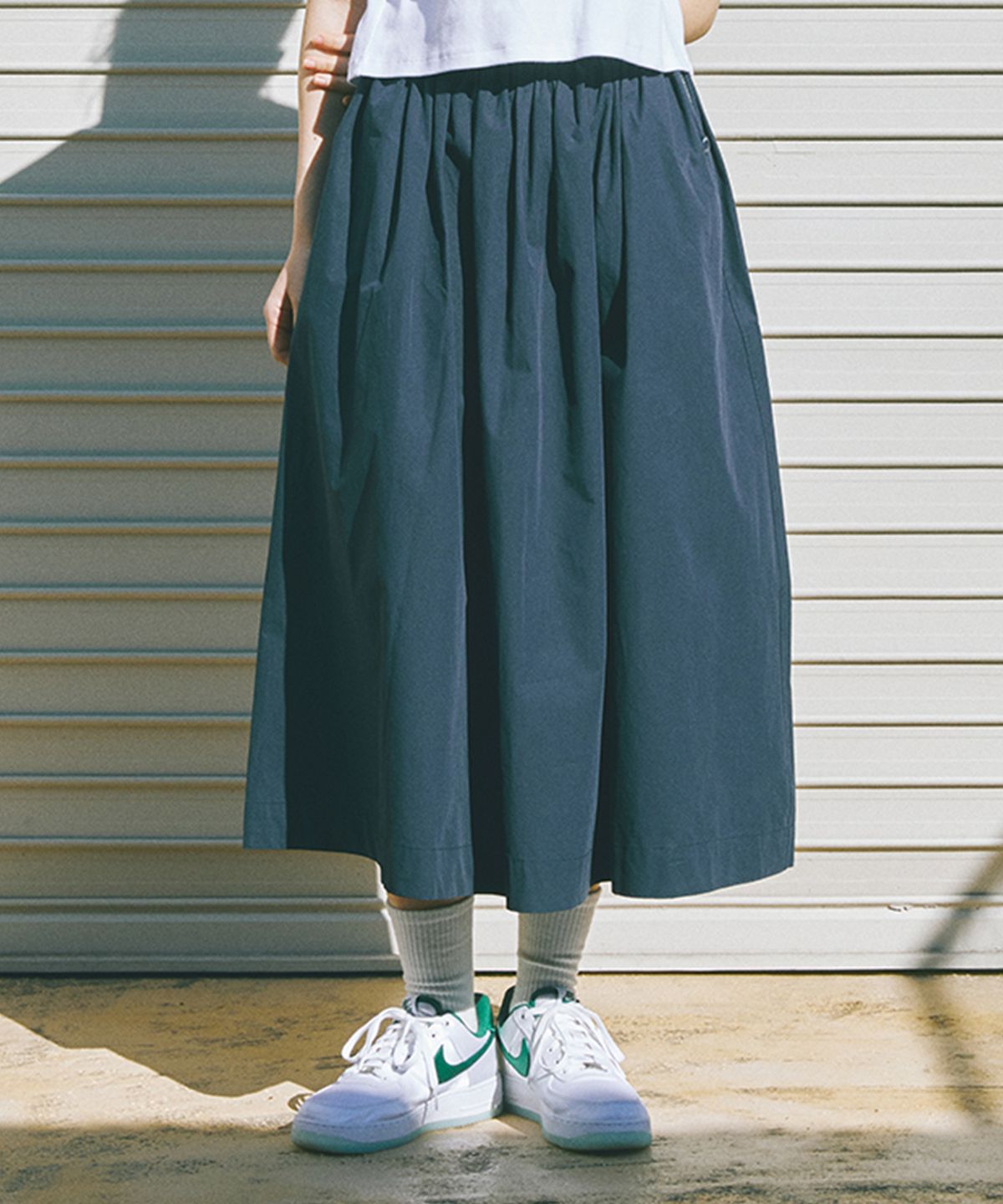 컬럼비아 유니버시티(COLUMBIA UNIVERSITY) ALL-ROUND PLEATS COTTON LONG SKIRTS 크라운네이비