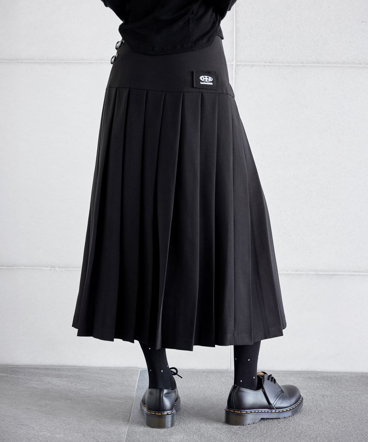 런던다다(LONDONDADA) LOGO PATCHED BUCKLE PLEATS SKIRT, BLACK