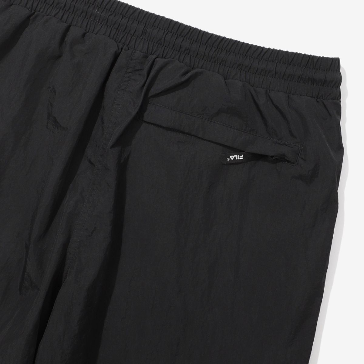 휠라(FILA) 루즈핏 나일론 우븐 조거 팬츠(FS2WPD3210XBLK)