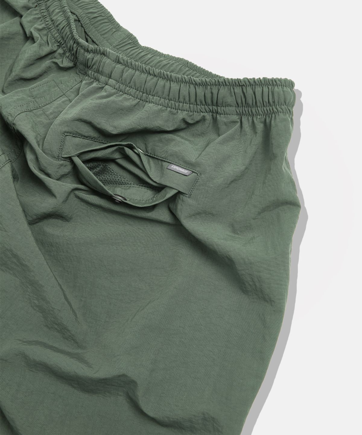 에스피오나지(ESPIONAGE) Nylon Warm Up Pants Olive
