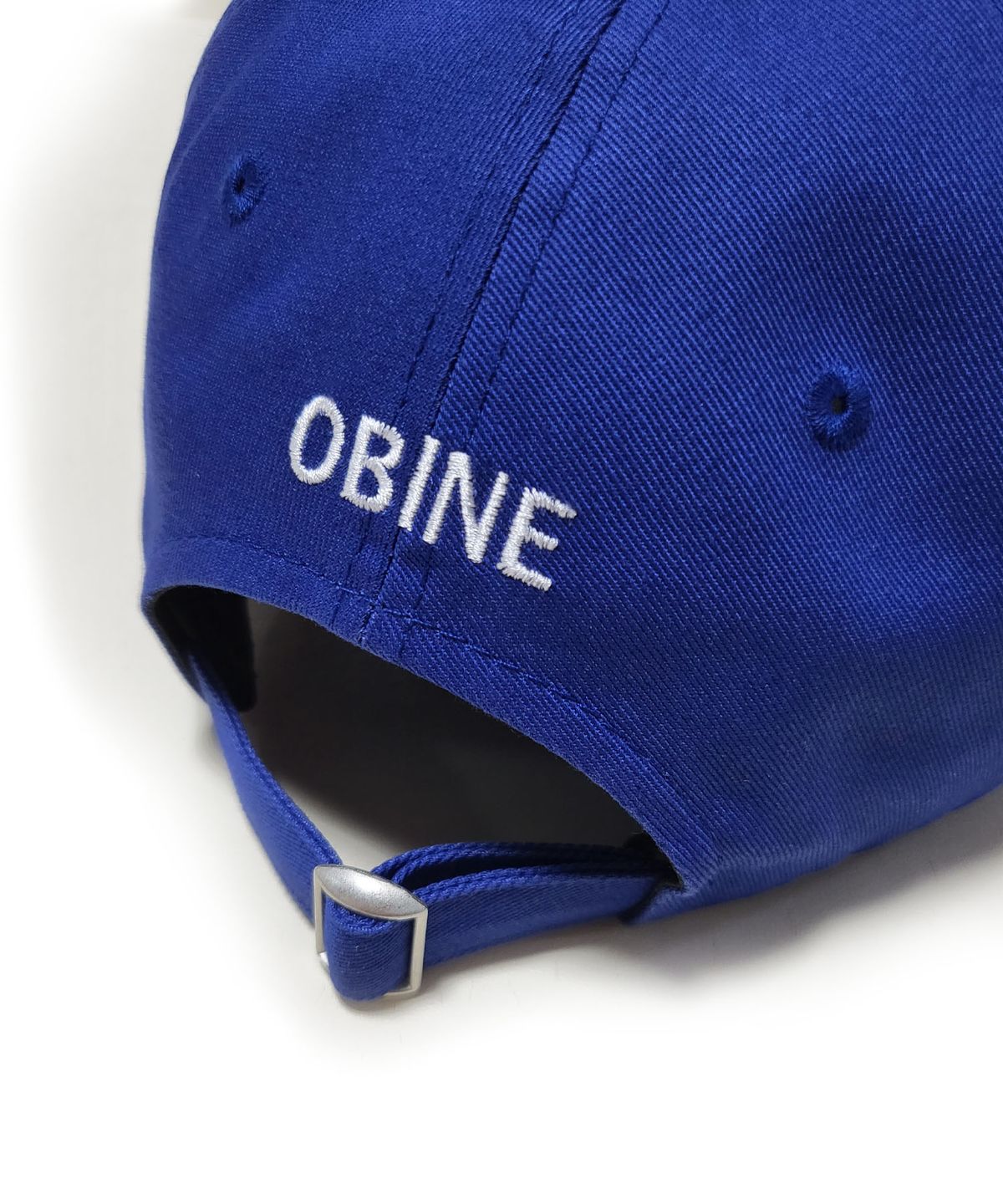 오바인(OBINE) ONE BITE IS NEVER ENOUGH 레터링 소프트 볼캡 블루
