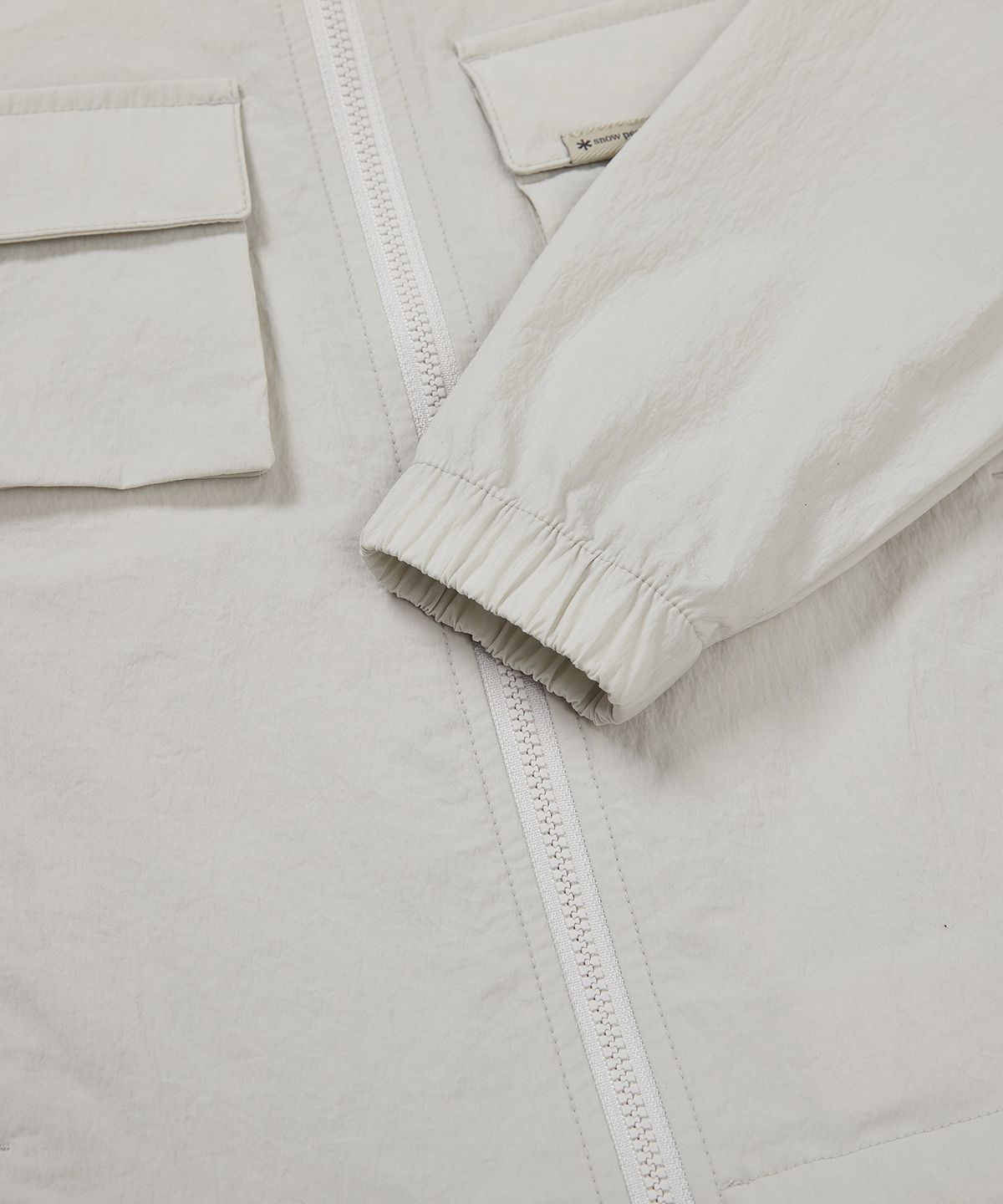 스노우피크 어패럴 키즈(SNOWPEAK APPAREL KIDS) 키즈 루트 아웃포켓 바람막이 Light Beige (S23MKRWB85)