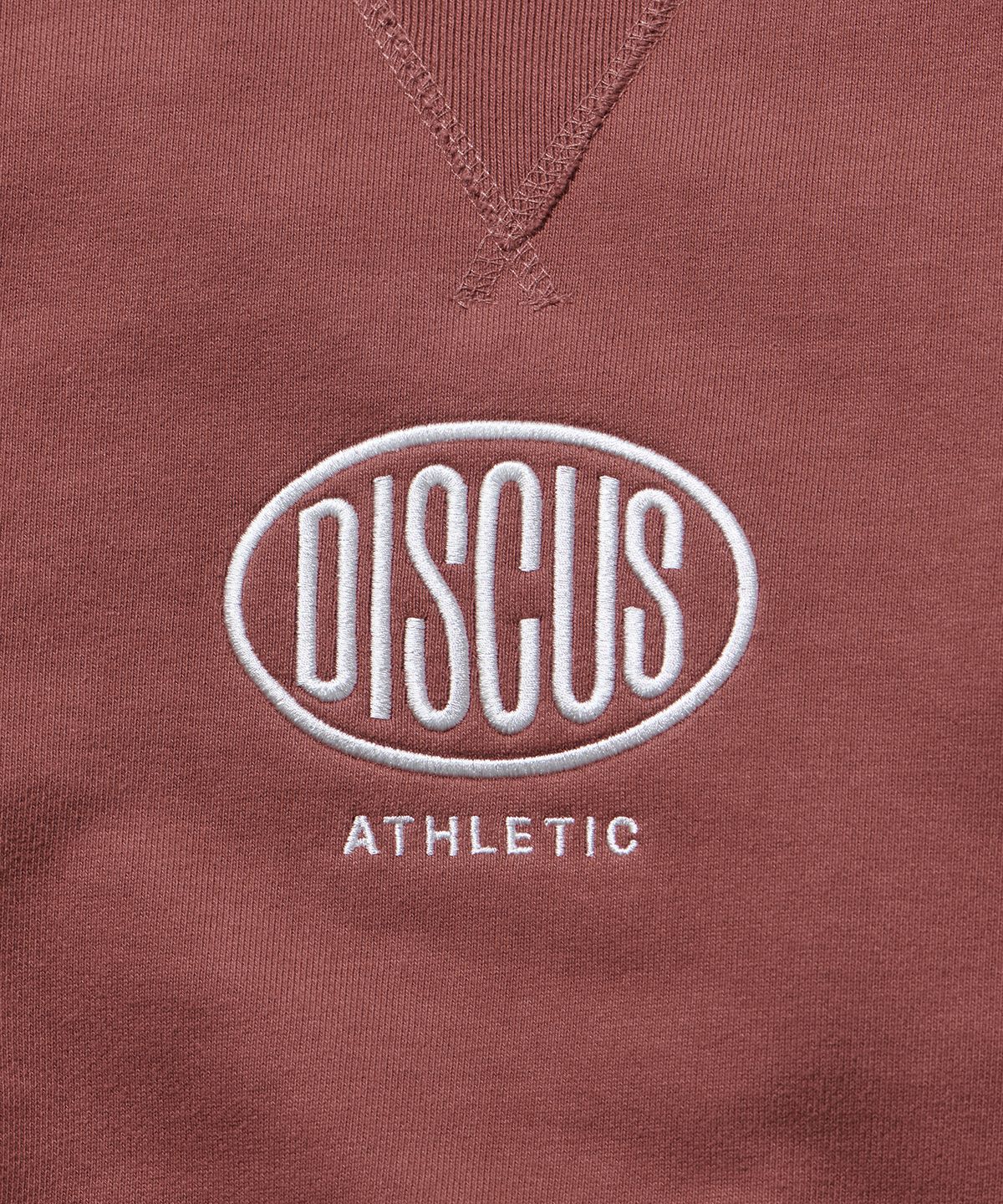 디스커스 애슬레틱(DISCUS ATHLETIC) 헤비웨이트 레귤러 핏 오발 로고 스웨트 셔츠 브릭 레드