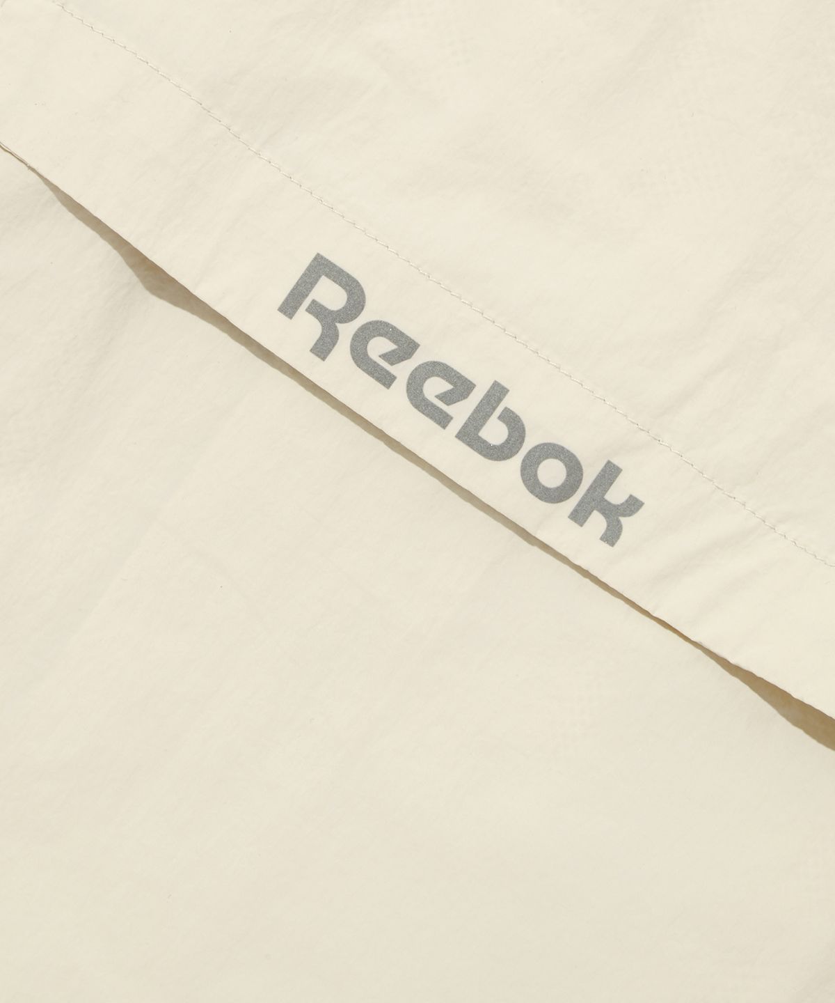 리복(REEBOK) 벡터 플래시 윈드 브레이커 - 베이지