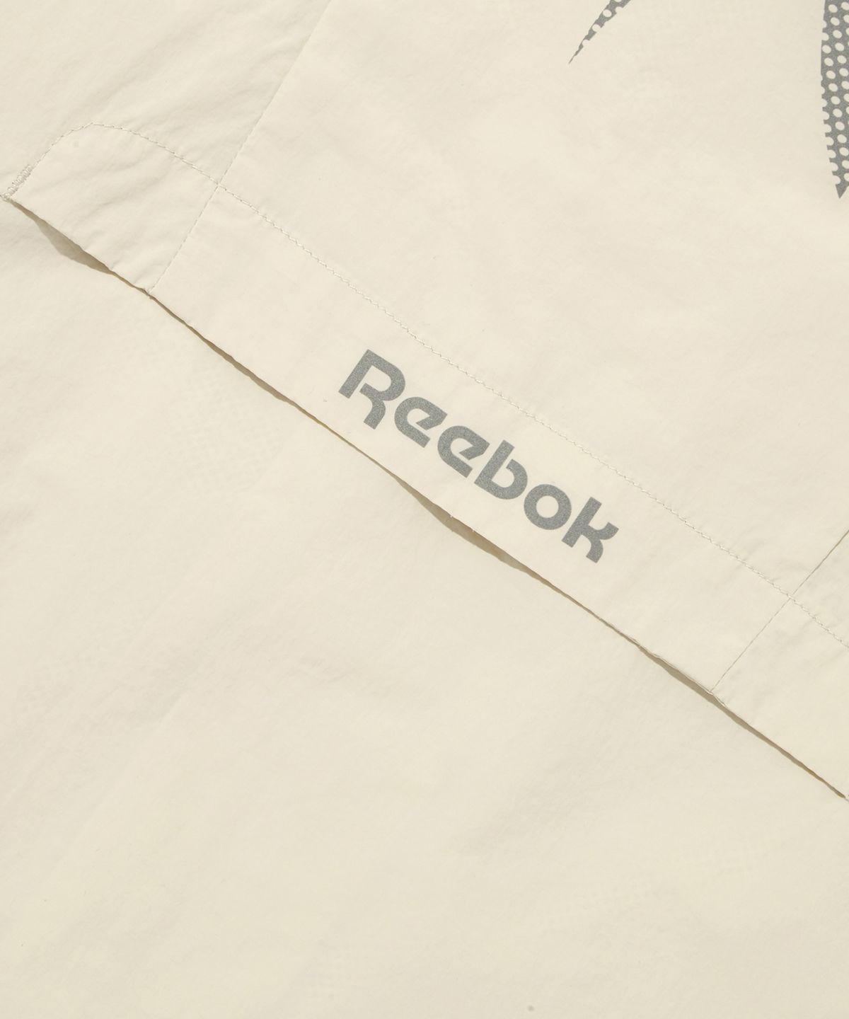 리복(REEBOK) 벡터 플래시 크롭 윈드 브레이커 (W) - 베이지