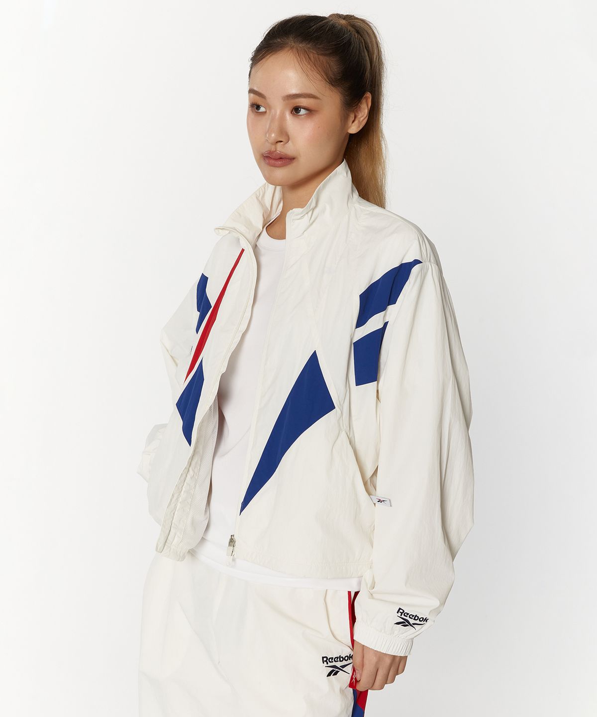 리복(REEBOK) 벡터 플래시 크롭 윈드 브레이커 (W) - 오프 화이트