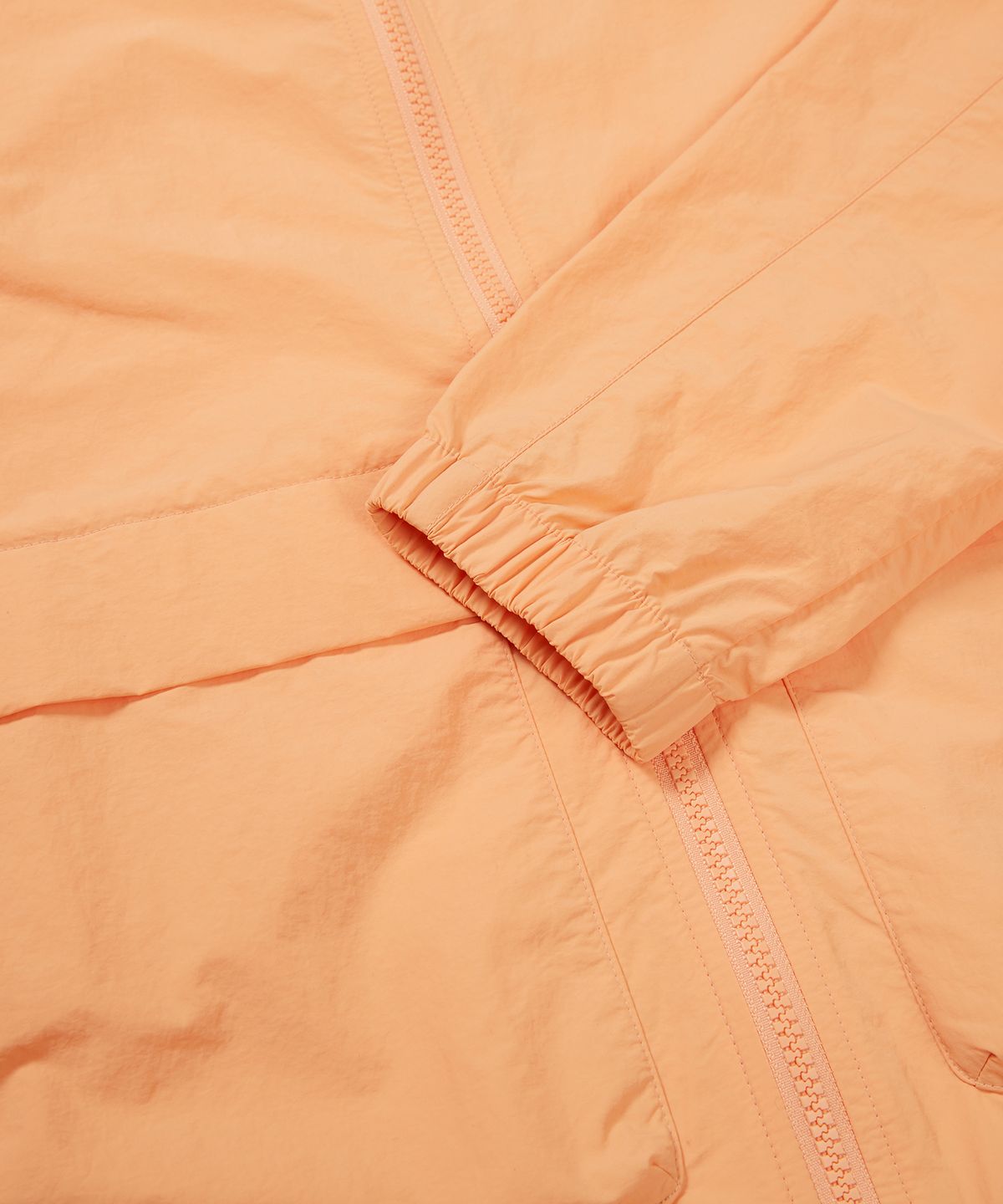 스노우피크 어패럴(SNOWPEAK APPAREL) 타슬란 여성 우븐 스탠드넥 바람막이 Light Orange (S24MWLWB51)