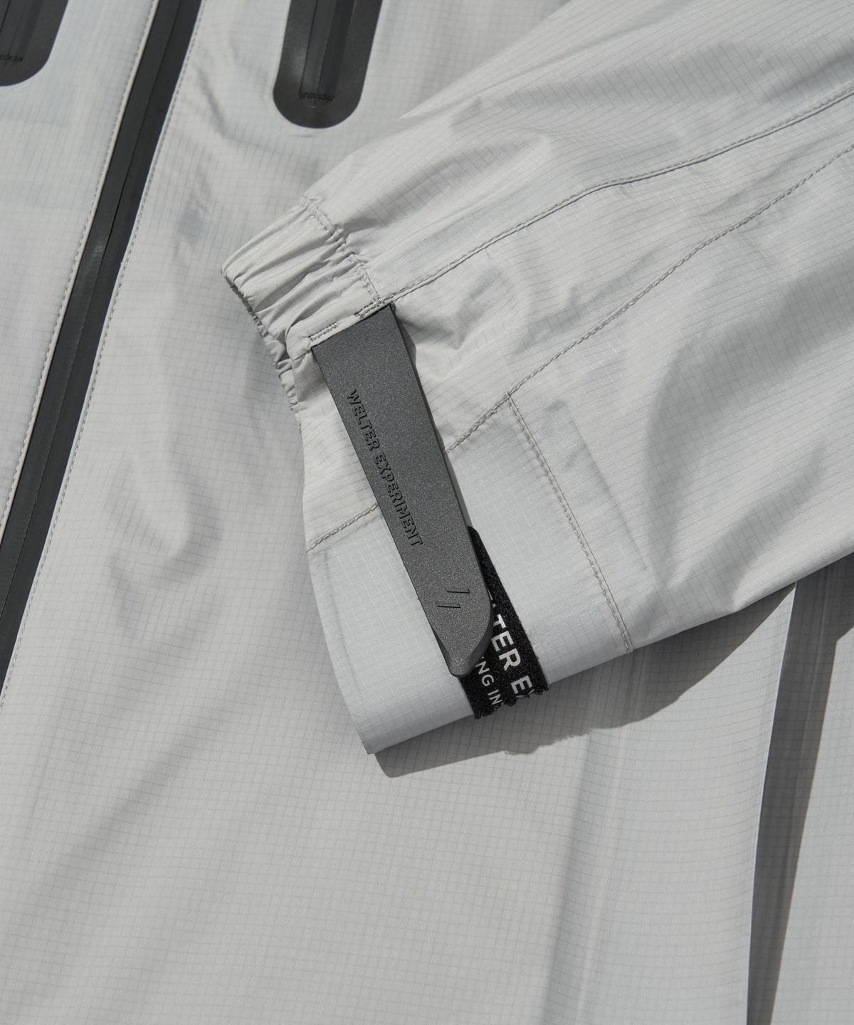 웰터 익스페리먼트(WELTER EXPERIMENT) 3LAYER REFLECTIVE STITCH JACKET_LIGHT GRAY_WOL056
