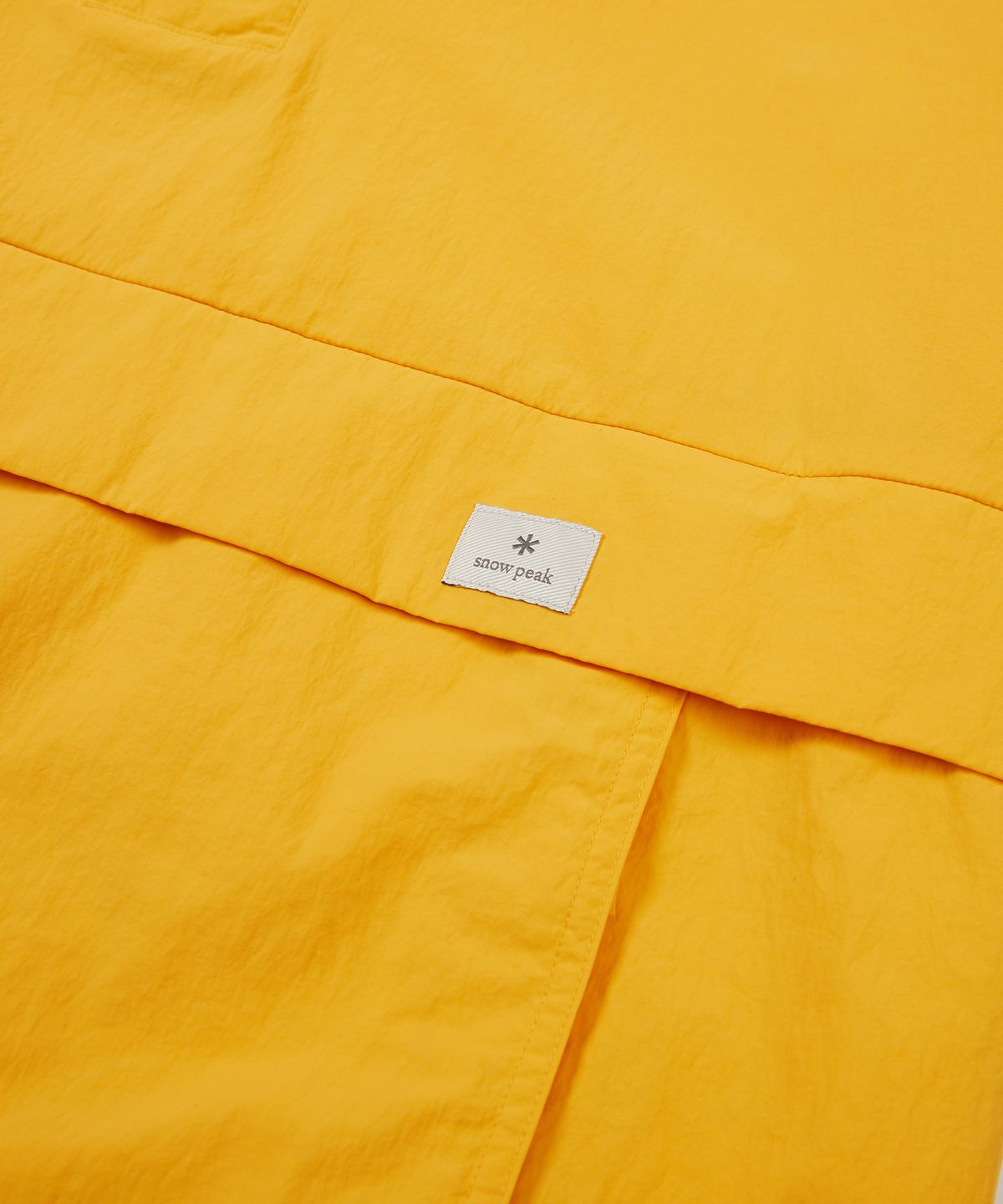 스노우피크 어패럴(SNOWPEAK APPAREL) 타슬란 우븐 비비드 반팔 아노락 Royal Yellow (S24MMLAN56)