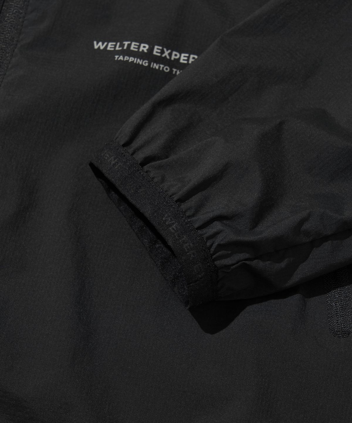 웰터 익스페리먼트(WELTER EXPERIMENT) LIGHT PACKABLE WINDBREAKER_BLACK_WOL058