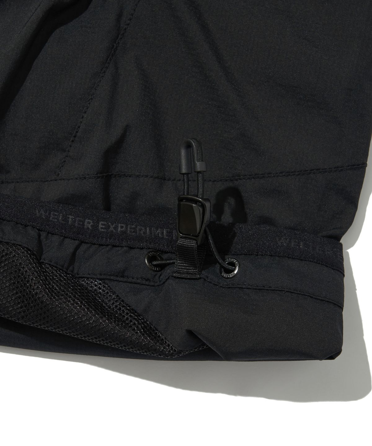 웰터 익스페리먼트(WELTER EXPERIMENT) DETACHABLE LIGHT WINDBREAKER_BLACK_WOL061