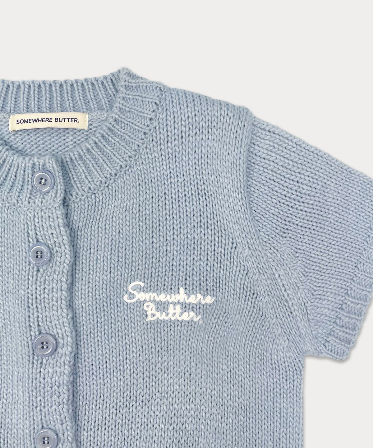 썸웨어버터(SOMEWHEREBUTTER) Letter Half Cardigan - Light Blue