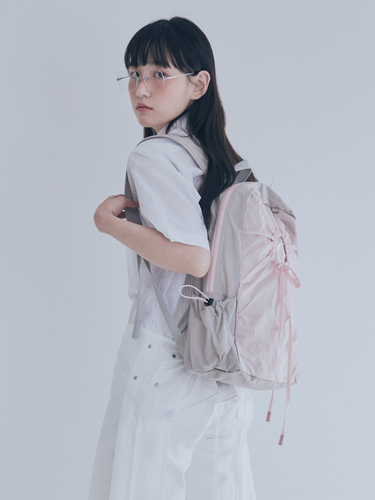 포이에(POIE) hole string PO backpack (pink gray)