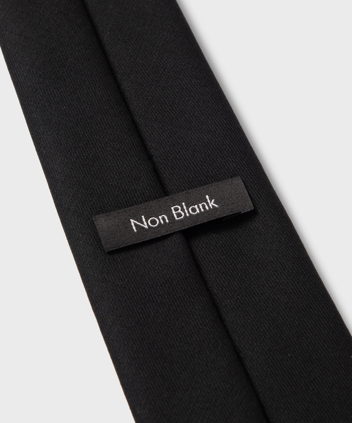 넌블랭크(NONBLANK) 울 100 솔리드 타이_BLACK
