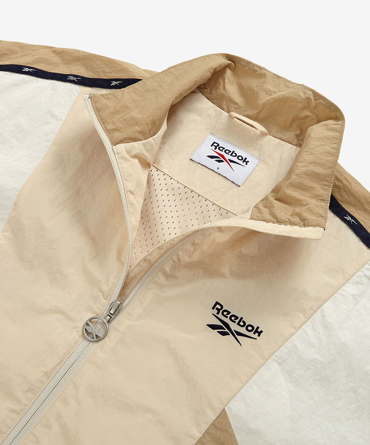 리복(REEBOK) 라이벌 크롭 윈드 브레이커 (W) - 베이지