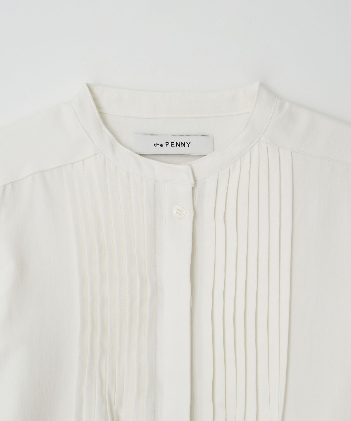 더페니(THE PENNY) PINTUCK RUFFLE BLOUSE - Ivory