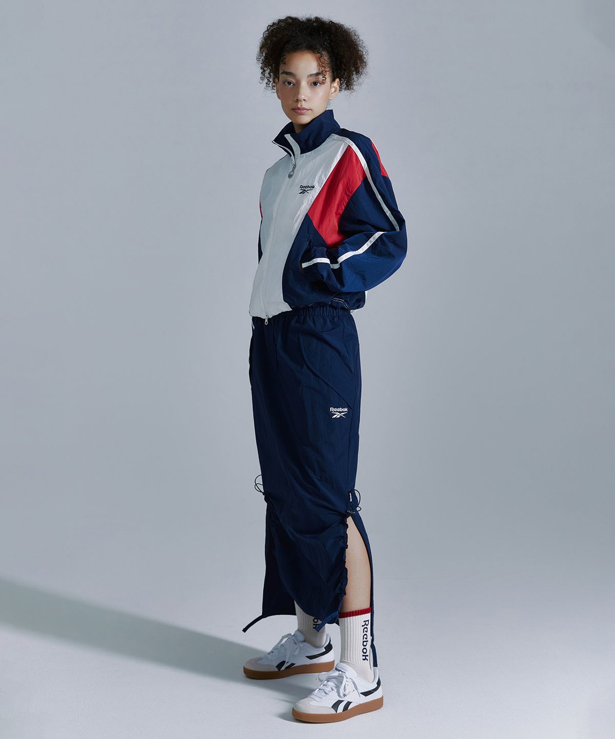 리복(REEBOK) 우븐 스트링 스커트 (W) - 네이비