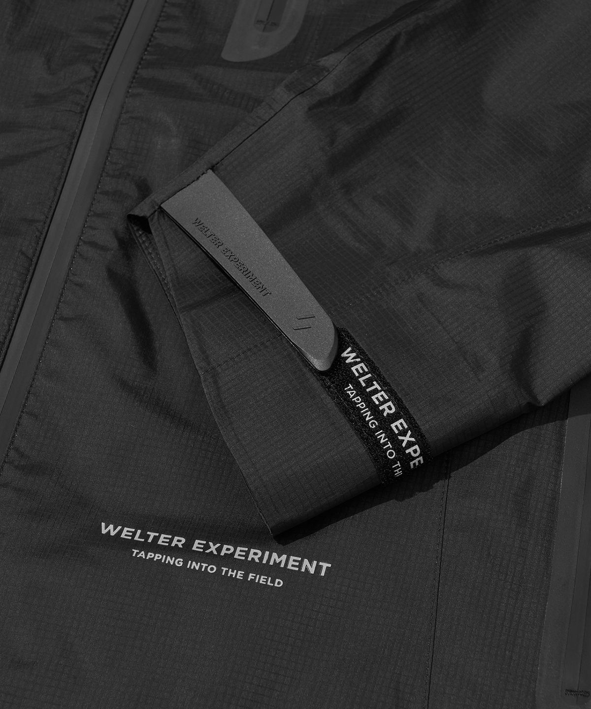 웰터 익스페리먼트(WELTER EXPERIMENT) 3LAYER SLIT REFLECTIVE HARD SHELL JACKET_BLACK_WOL063