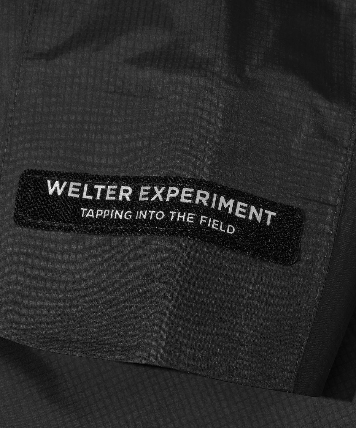 웰터 익스페리먼트(WELTER EXPERIMENT) 3LAYER SLIT REFLECTIVE HARD SHELL JACKET_BLACK_WOL063
