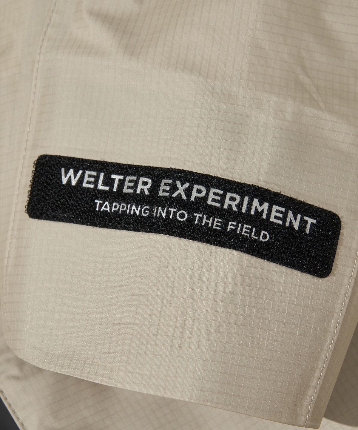 웰터 익스페리먼트(WELTER EXPERIMENT) 3LAYER SLIT REFLECTIVE HARD SHELL JACKET_CREAM_WOL064