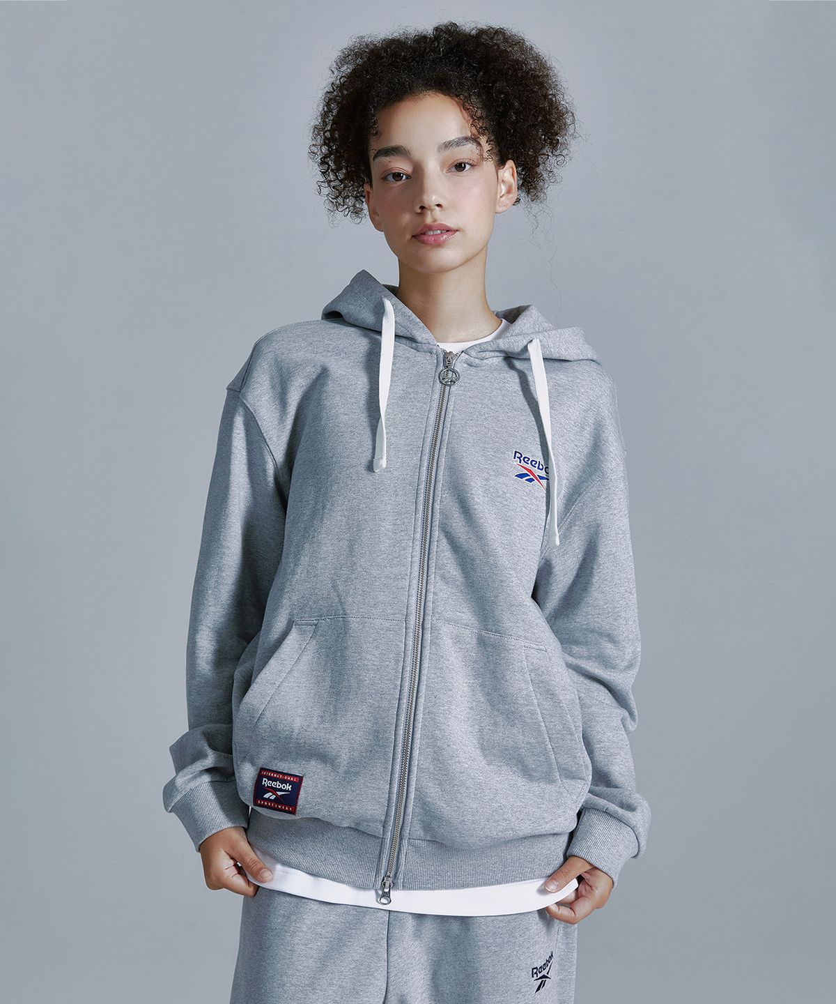 리복(REEBOK) 벡터 후드집업 - 그레이