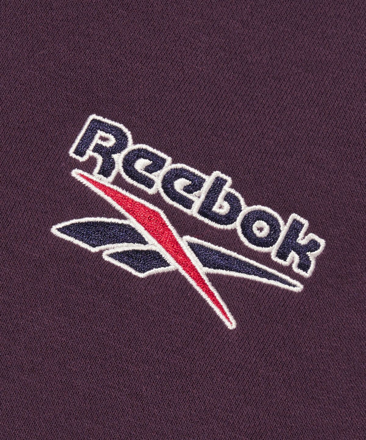 리복(REEBOK) 레터링 기모 하프 집업 - 다크 퍼플