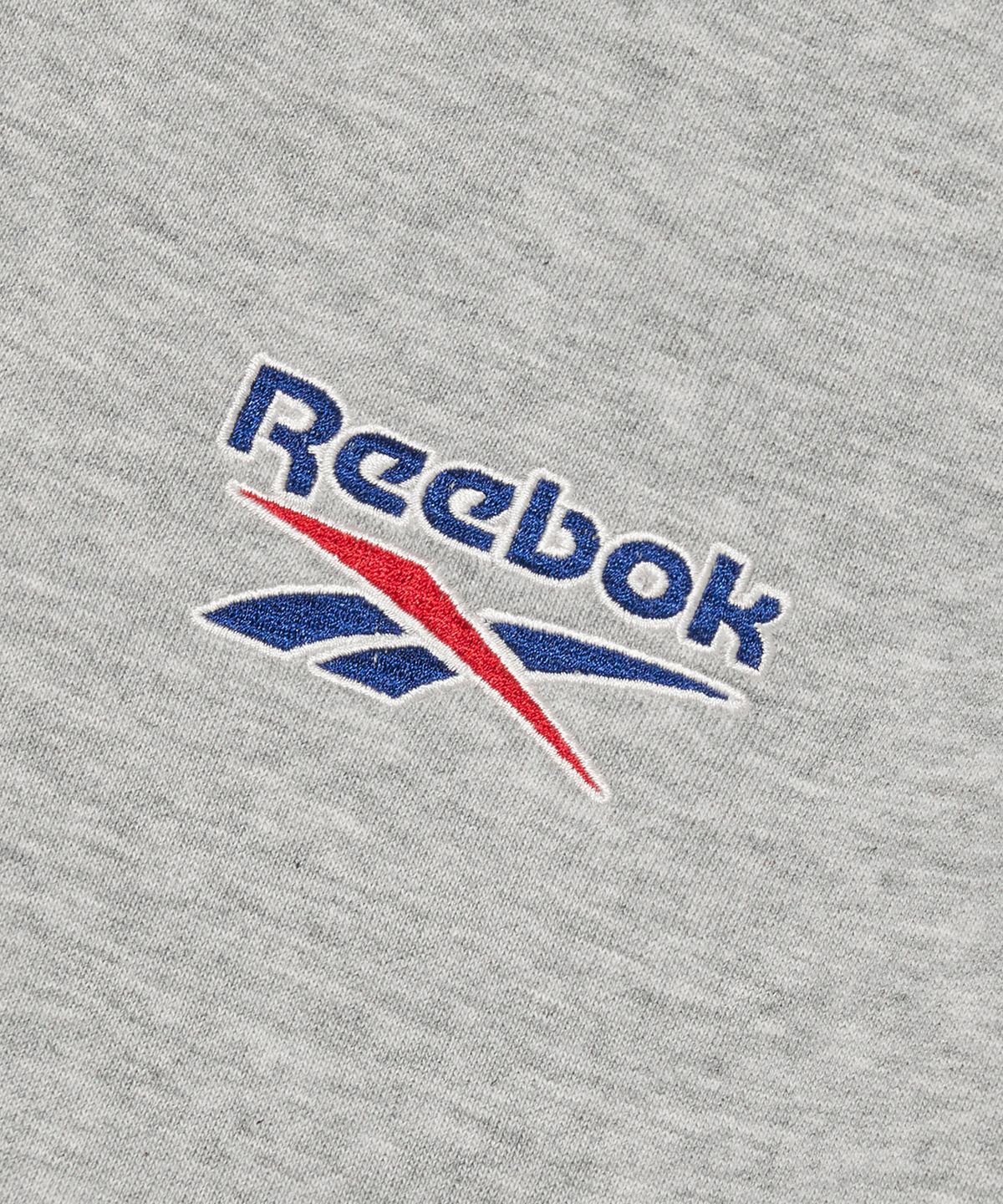 리복(REEBOK) 레터링 기모 하프 집업 - 그레이