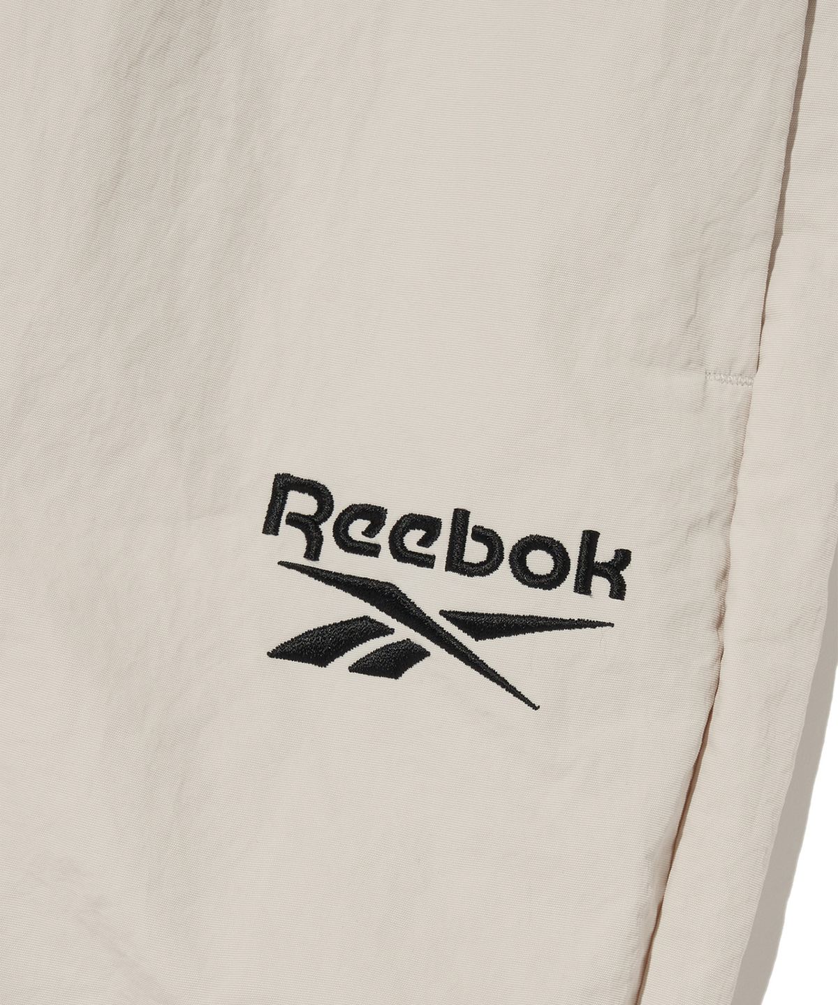 리복(REEBOK) 에센셜 웜업 팬츠 - 베이지
