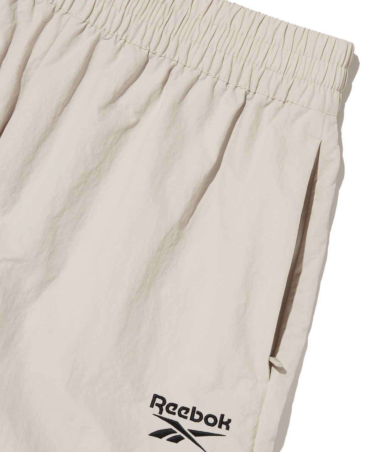 리복(REEBOK) 에센셜 웜업 팬츠 - 베이지
